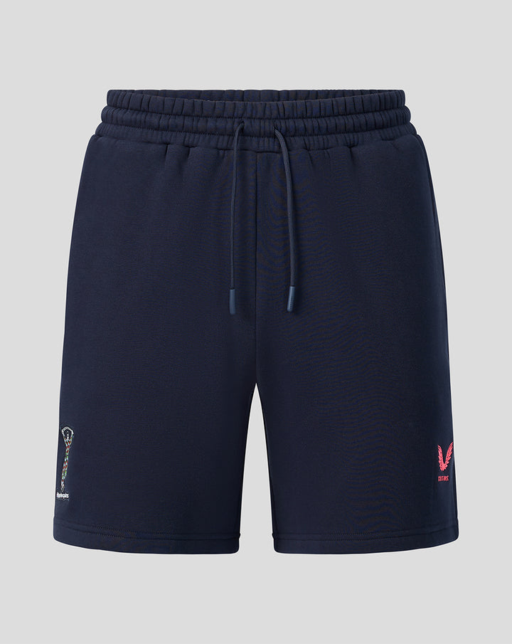 Front view of navy Harlequins Travel Shorts with a drawstring waist and a left leg embroidered patch.
