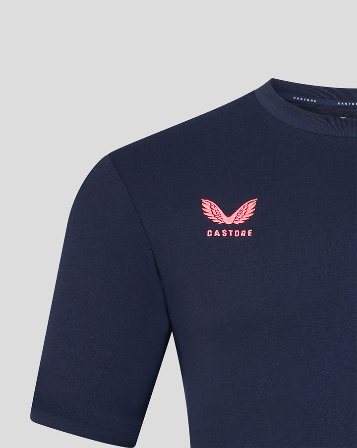 Close-up of pink Castore logo on navy Harlequins travel T-shirt left chest.