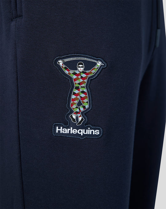 Close up of navy Harlequins Travel Joggers showing the multicolor Harlequins crest patch.