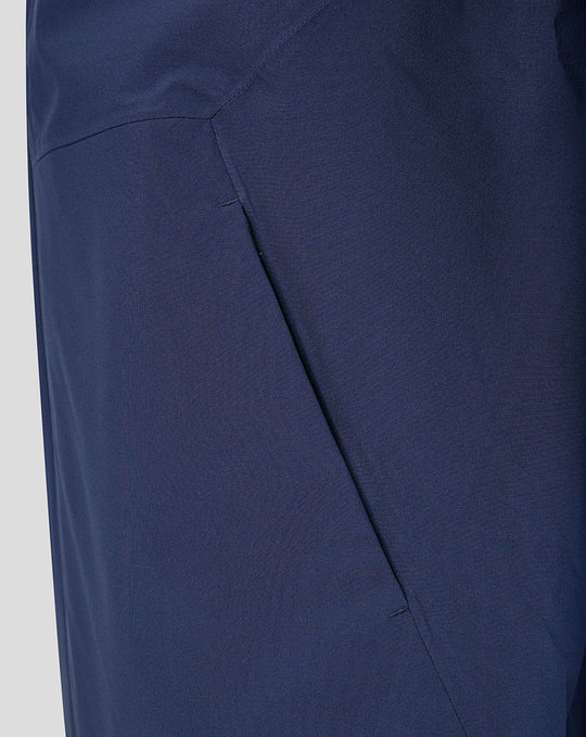Close-up of deep navy fabric and angular seam detailing on the Harlequins training rain jacket