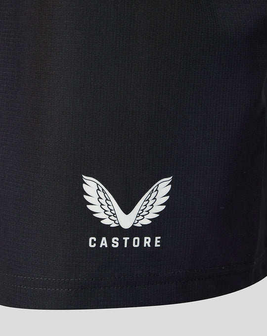 Close up of the shorts hem showing the Castore logo with wings on black fabric