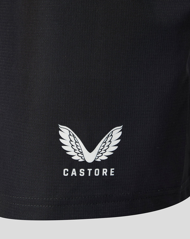 Close up of the shorts hem showing the Castore logo with wings on black fabric