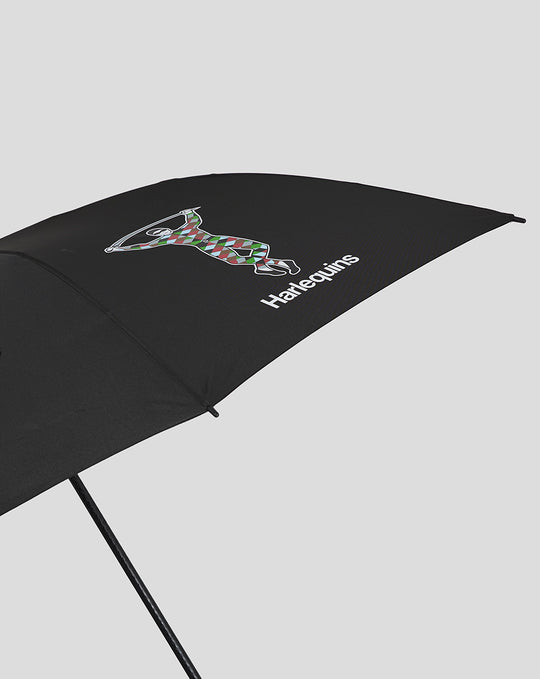 Close up of black Harlequins golf umbrella canopy showing colorful harlequin figure and logo.