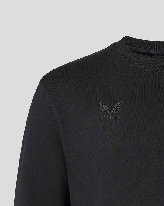 Close-up of chest area showing tonal Harlequins crest and Castore branding on black sweatshirt