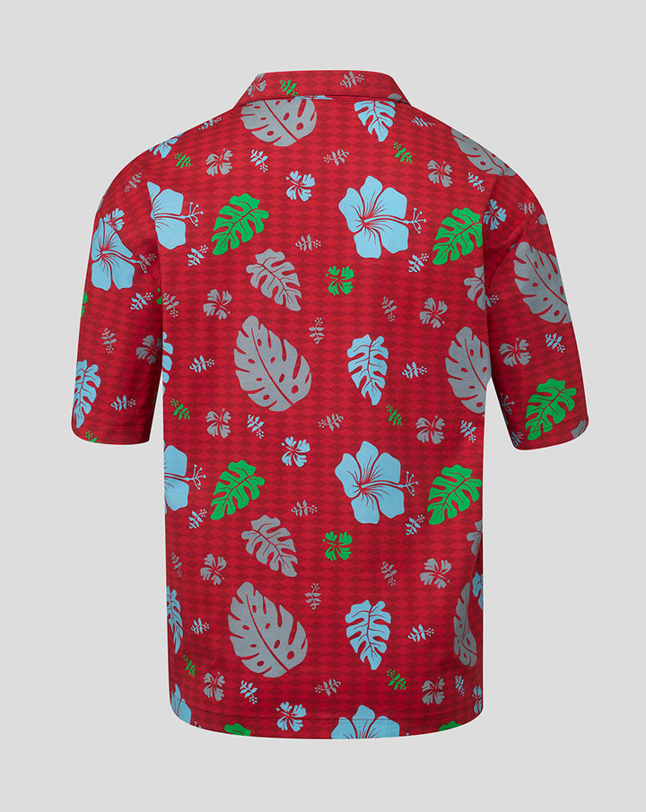 Back view of red Big Summer Kick-Off Hawaiian shirt with pastel blue hibiscus and gray Monstera leaves.