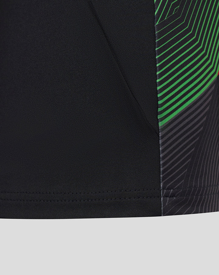 Close-up of the midlayer side hem with black fabric and neon green stripe panel.