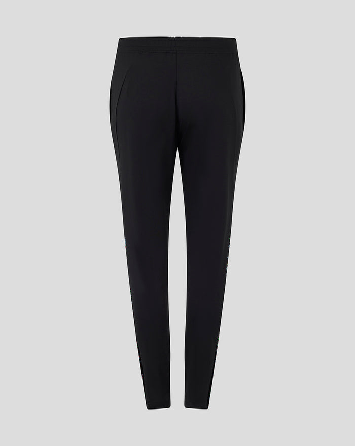 Back view of black women's training knit pants with elastic waistband and subtle side pockets