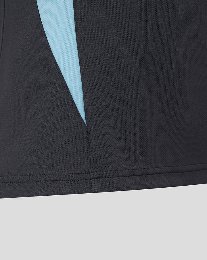 Close up of ebony Harlequins polo showing a light blue side panel and neat hem.