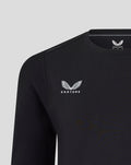 Close-up of black Harlequins travel tee showing Castore logo on the left chest and Harlequins crest on the right.