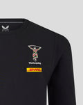 Close up of a black Harlequins travel tee showing the Harlequins crest and DHL sponsor on the chest.