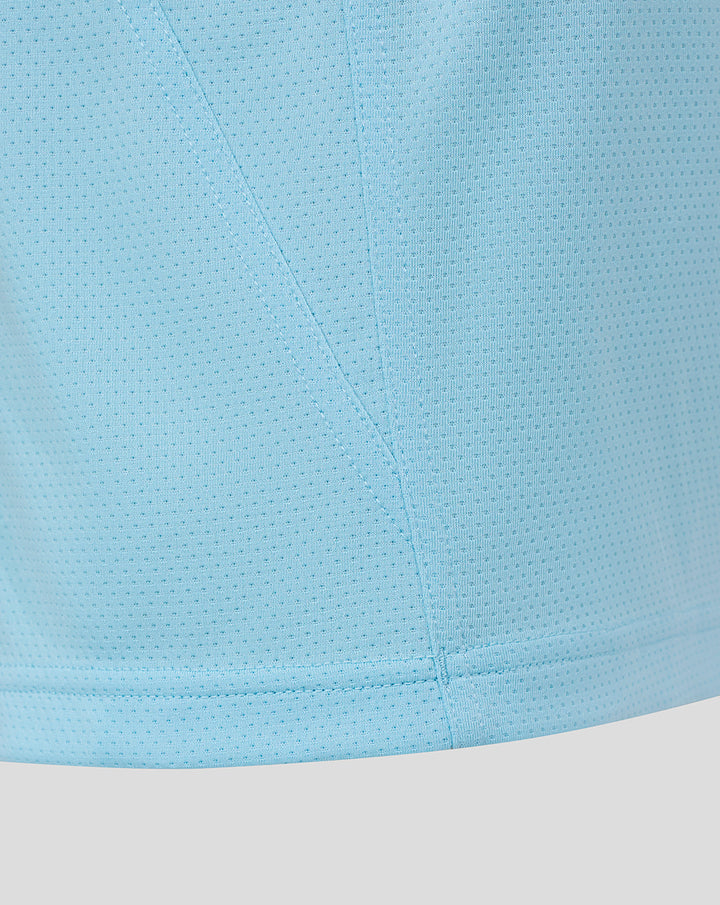 Close up of light sky blue breathable fabric with a stitched seam from the junior training short sleeve tee
