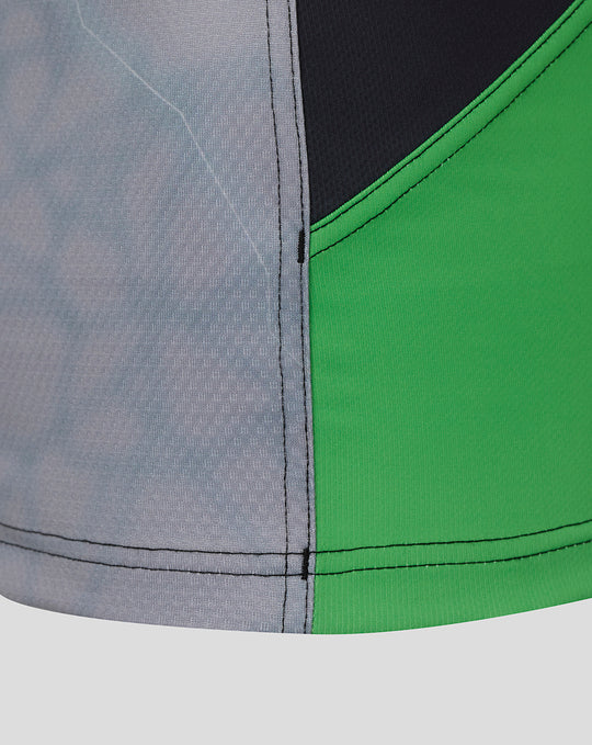 Close up of the women's 25/26 Pro Home Shirt fabric showing grey black and green panels and stitching details