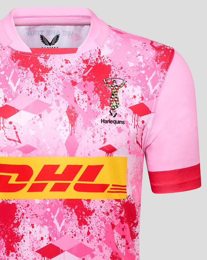 Close-up of pink Harlequins away replica rugby shirt with splatter pattern, Harlequins crest and DHL logo.
