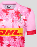 Close-up of pink Harlequins away replica rugby shirt with splatter pattern, Harlequins crest and DHL logo.