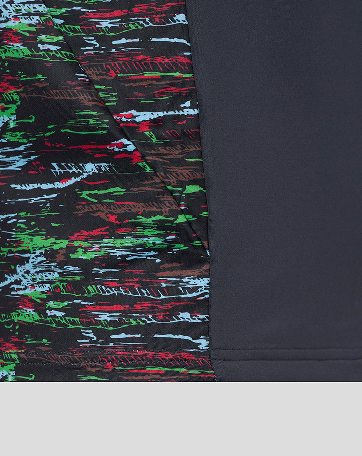 Close up of navy Harlequins training top showing a multicolor abstract print panel on the left side against solid navy fabric.