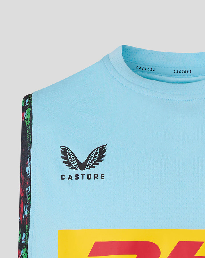 Shoulder and chest close-up of sky blue vest with colorful patterned trim and Castore branding at the neckline
