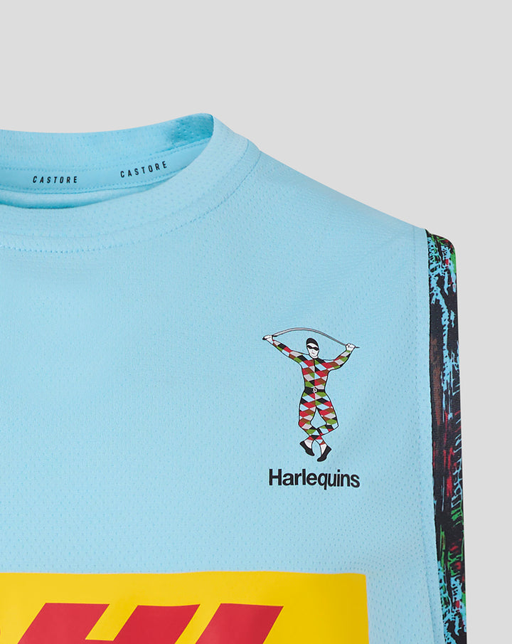 Close-up of a sky blue vest chest showing Harlequins crest, Castore branding at the neck and colorful side trim