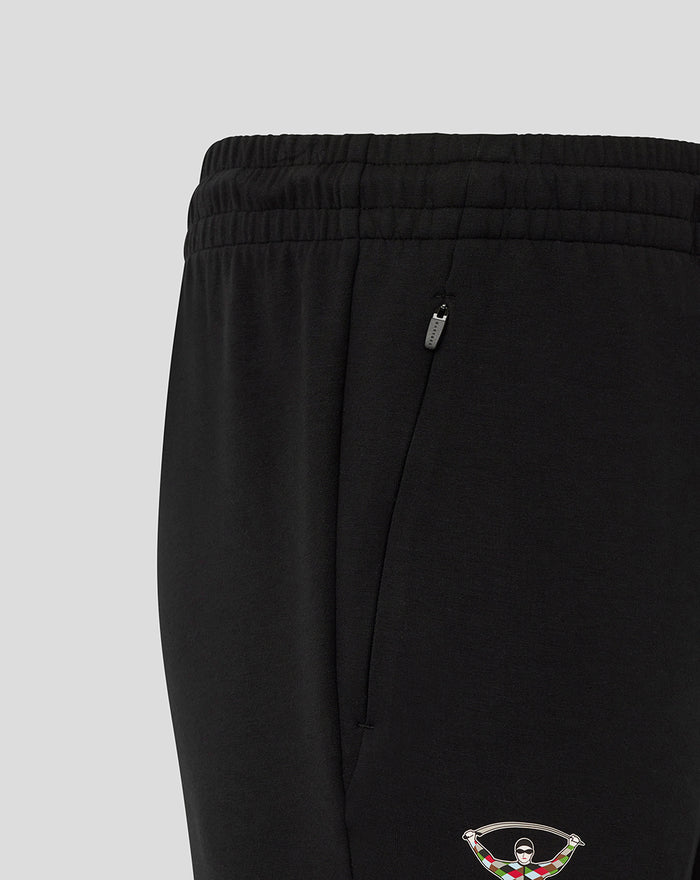 Close up of zip pocket and Harlequins crest at the lower leg of black travel pants