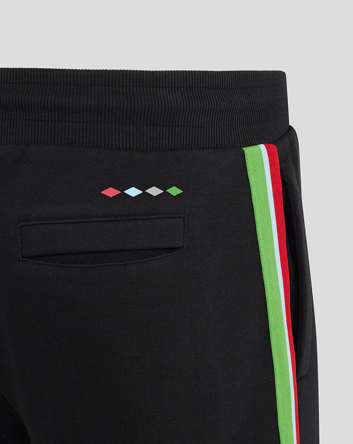 Back view of black men's shorts featuring colorful diamond motifs above the back pocket and a vibrant side stripe.