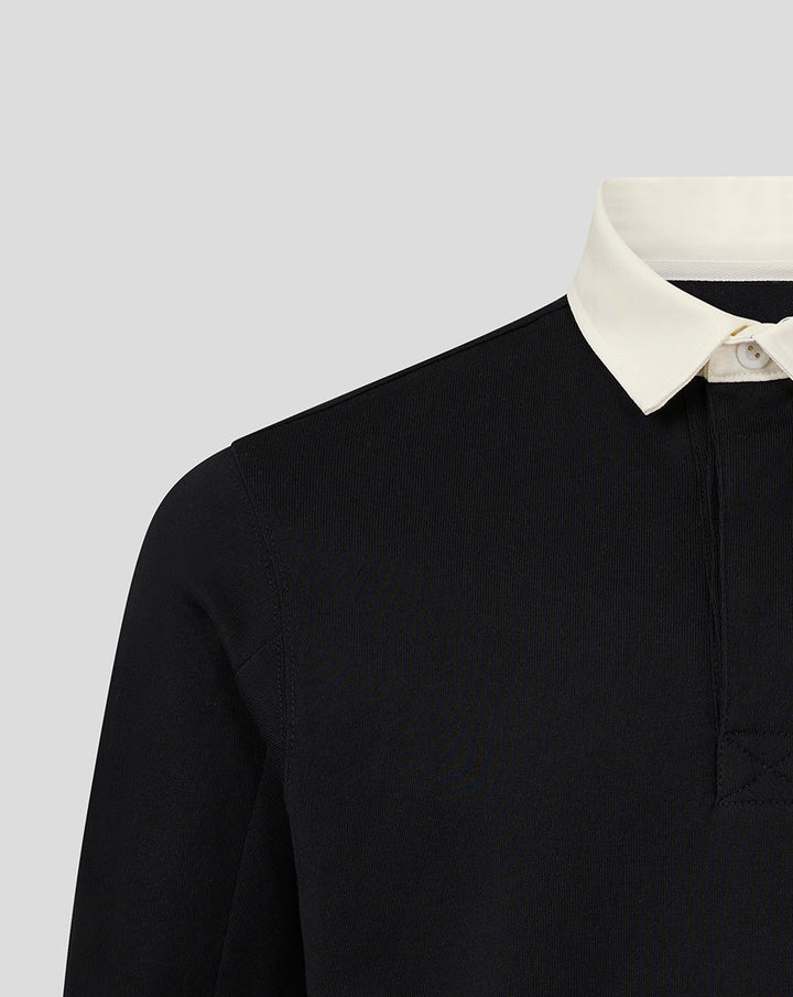 Close-up of the black rugby shirt showing a white contrast collar and placket
