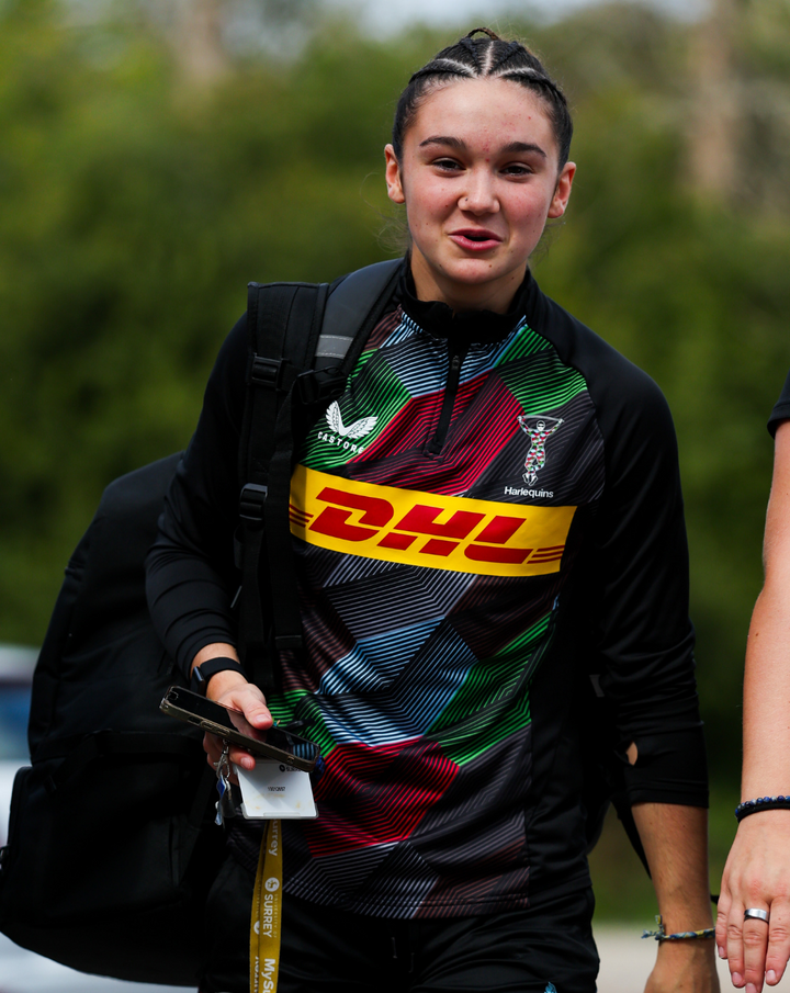 Harlequins matchday midlayer top worn by a player outdoors with DHL logo across the chest